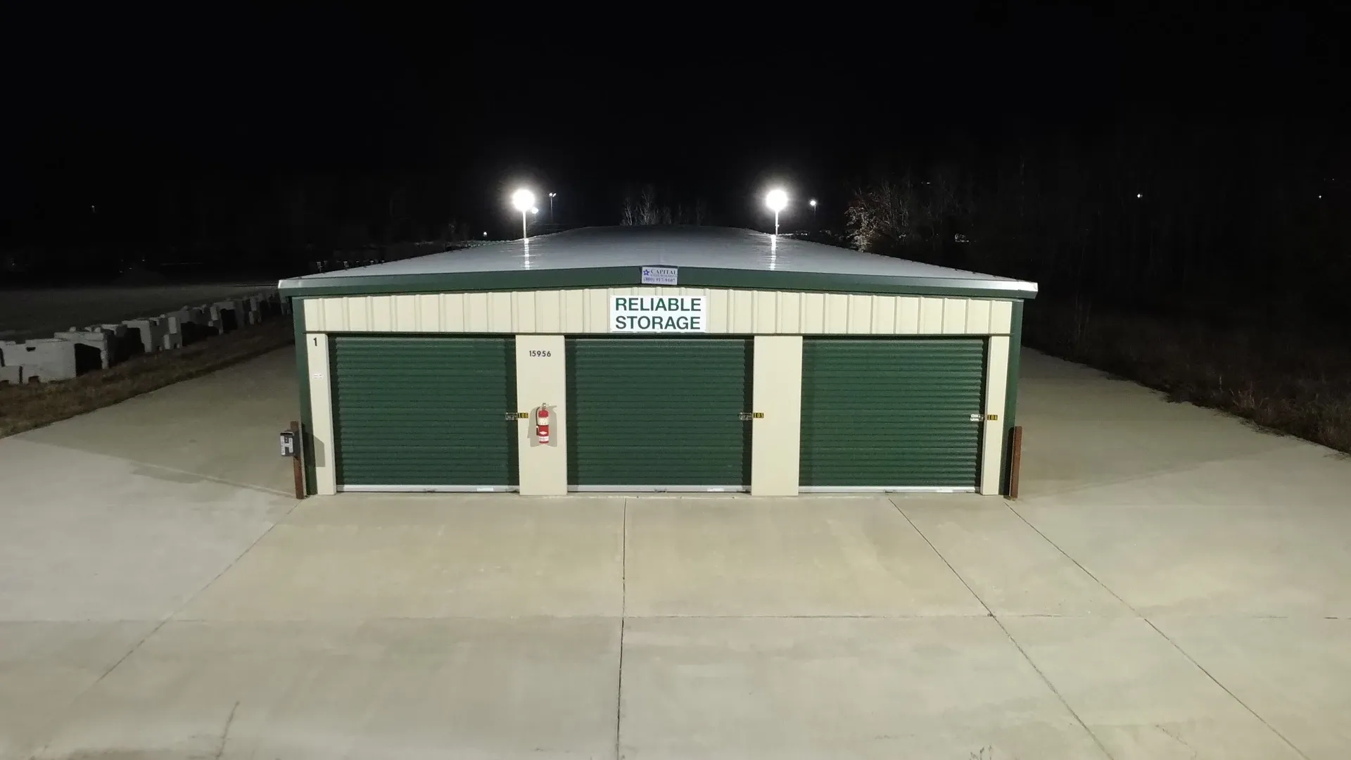 Drive up units brightly lit at night at Reliable Storage